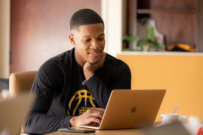 Student focusing on laptop