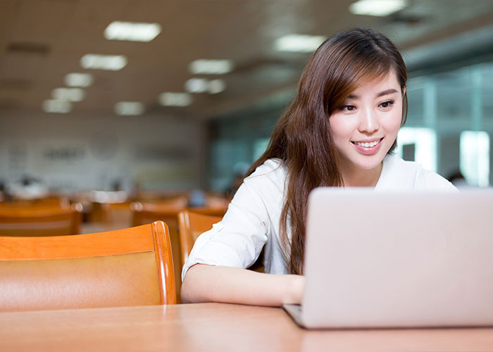 Young student is focusing on her laptop