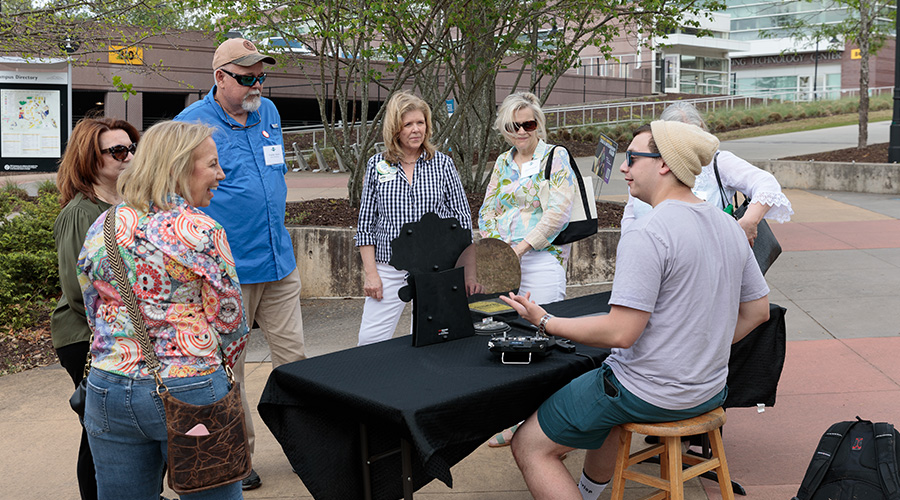 SPSU alumni talking with KSU student