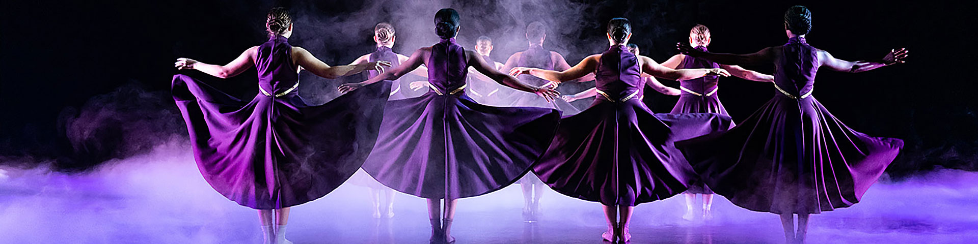 dancers in purple gowns