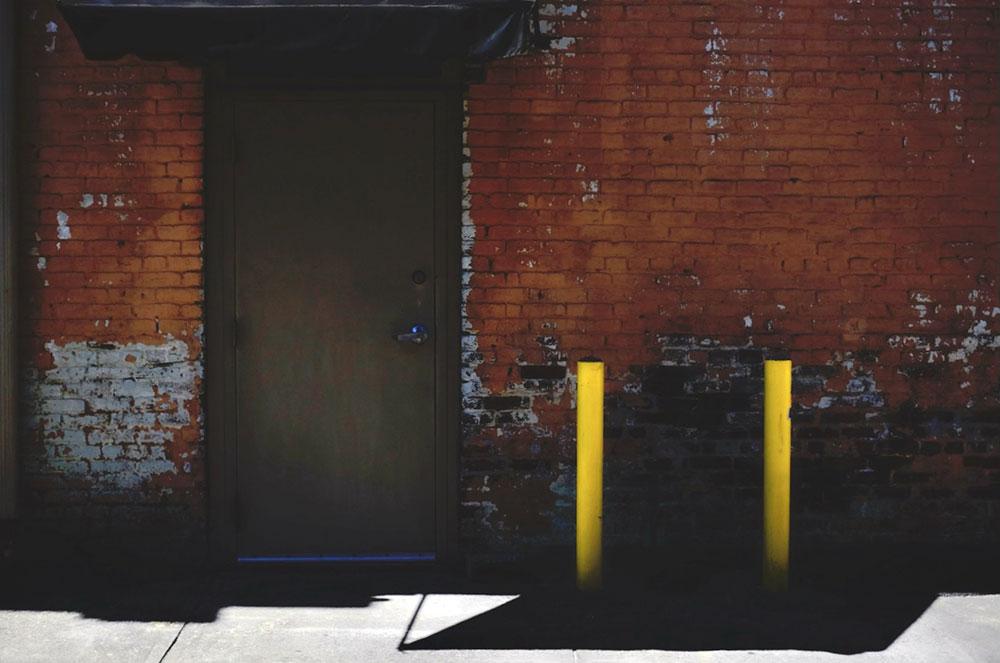 brick wall with door and barriers