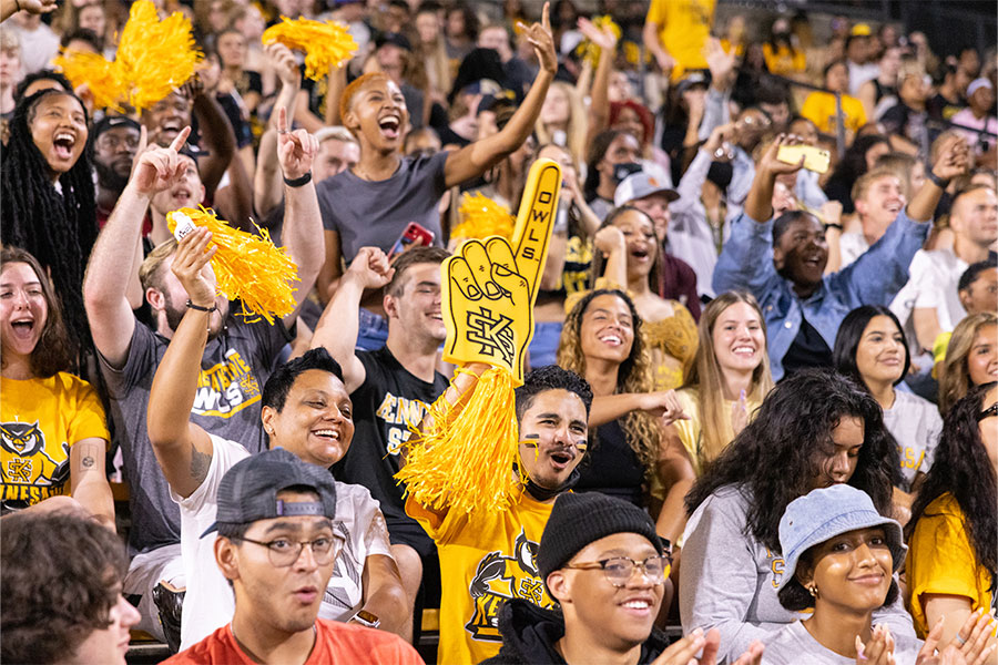 large group of students in the bleachers supporting the team.