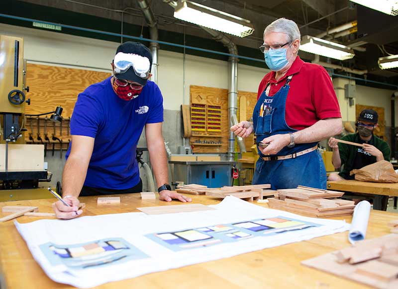 cacm student and faculty member working in the wood lab