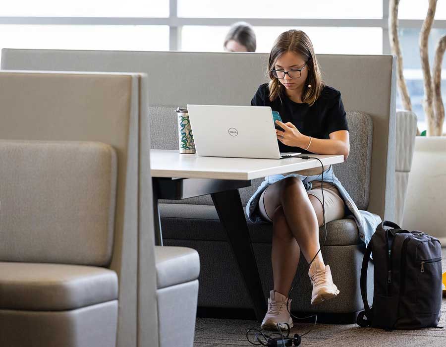 ksu graduate student using their laptop.