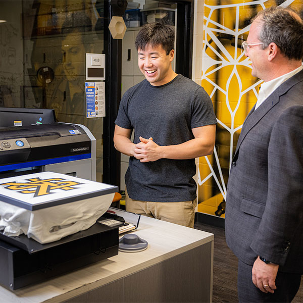 ksu student using the 3d printer for class work