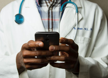 photo of ksu doctor checking schedule on phone