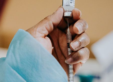 photo of nurse filling syringe