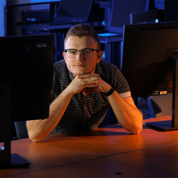 coles economics student sitting in front on computer