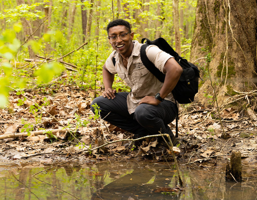 ksu student at alatoona creek park doing field work