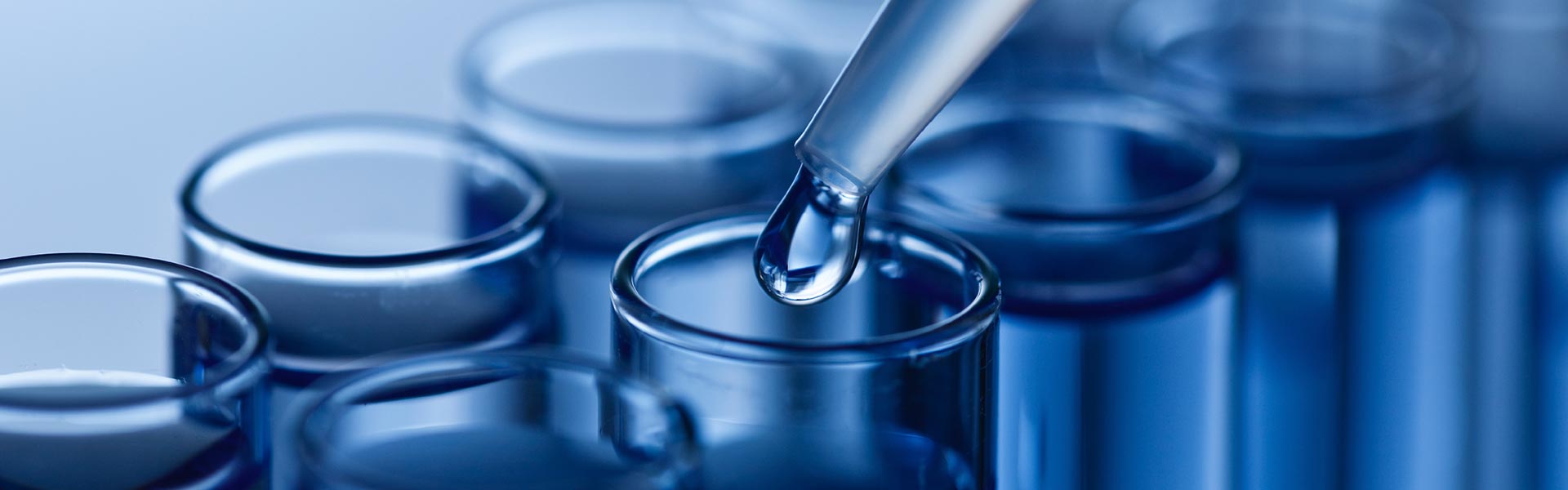 Photo of a drop of liquid into tubes during a research experiment