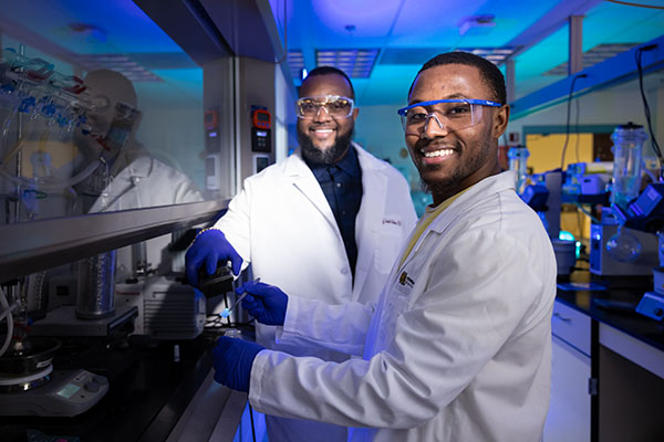 Photo of research faculty and student working in a lab