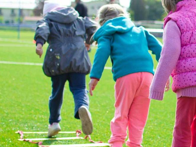 Young children doing ladder exercises