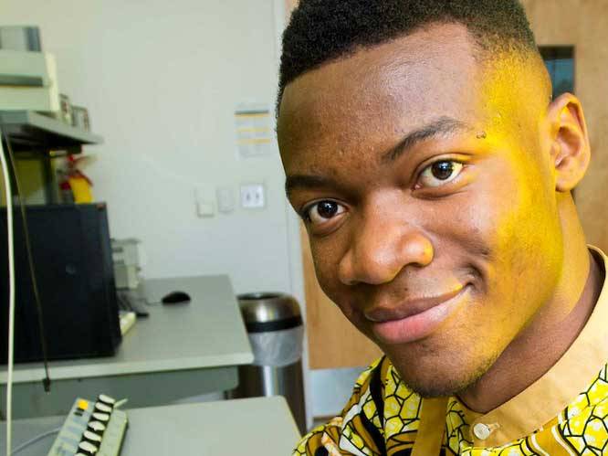 Man sitting at a desk smiling for a picture