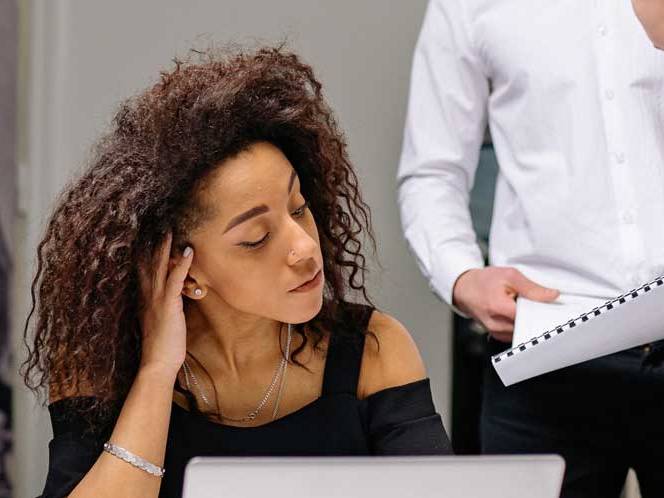 Business woman looking down focusing on laptop