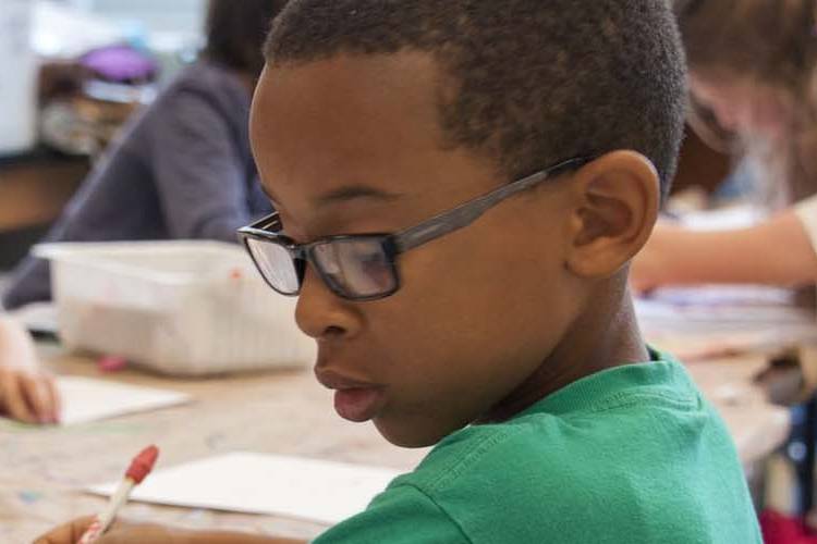 Young child focusing on school work