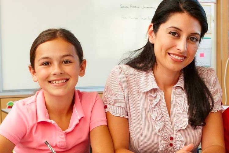 Teacher and young student smiling for a picture