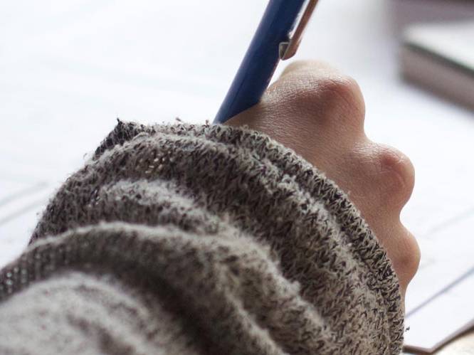 Student is writing with pen