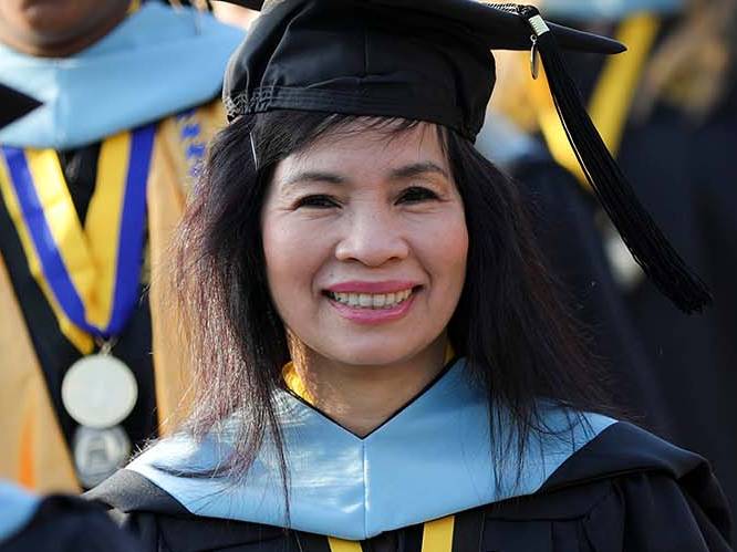 Student graduating smiling