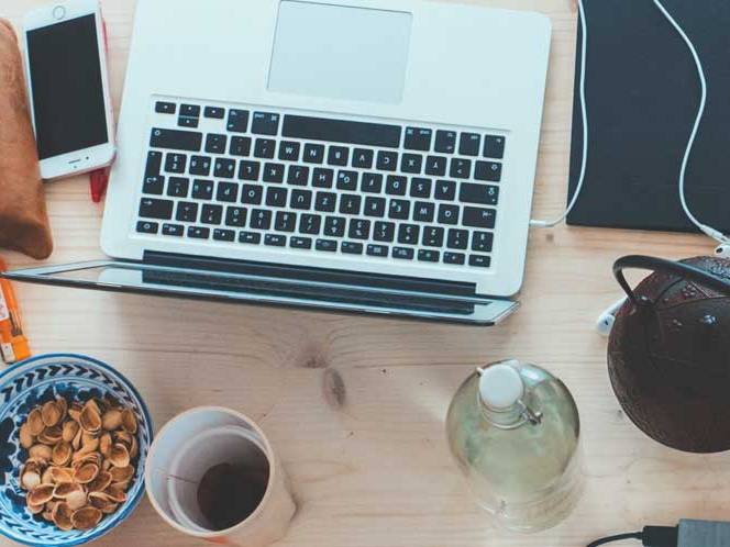 Top view of a laptop,snacks, and coffee