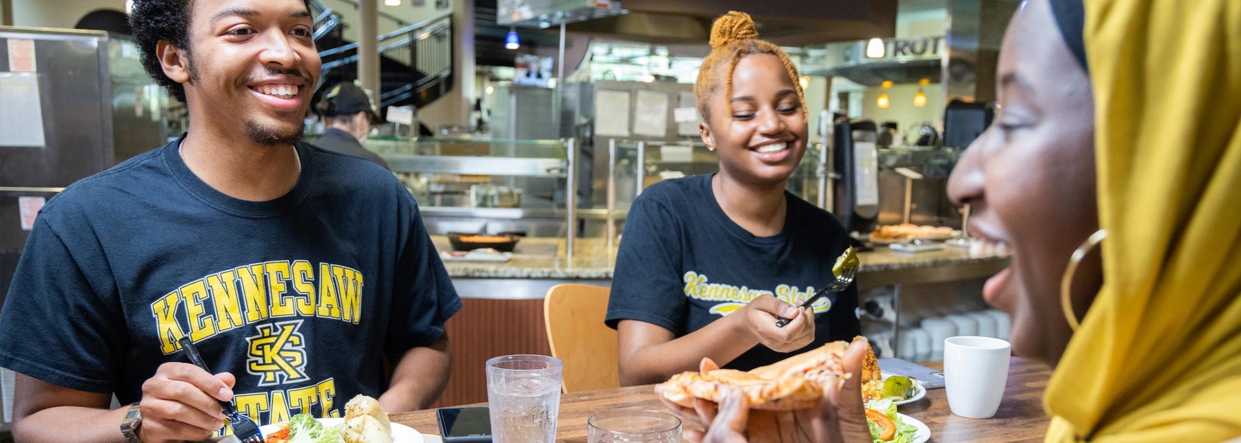 Residential students sitting at a table in the dining hall