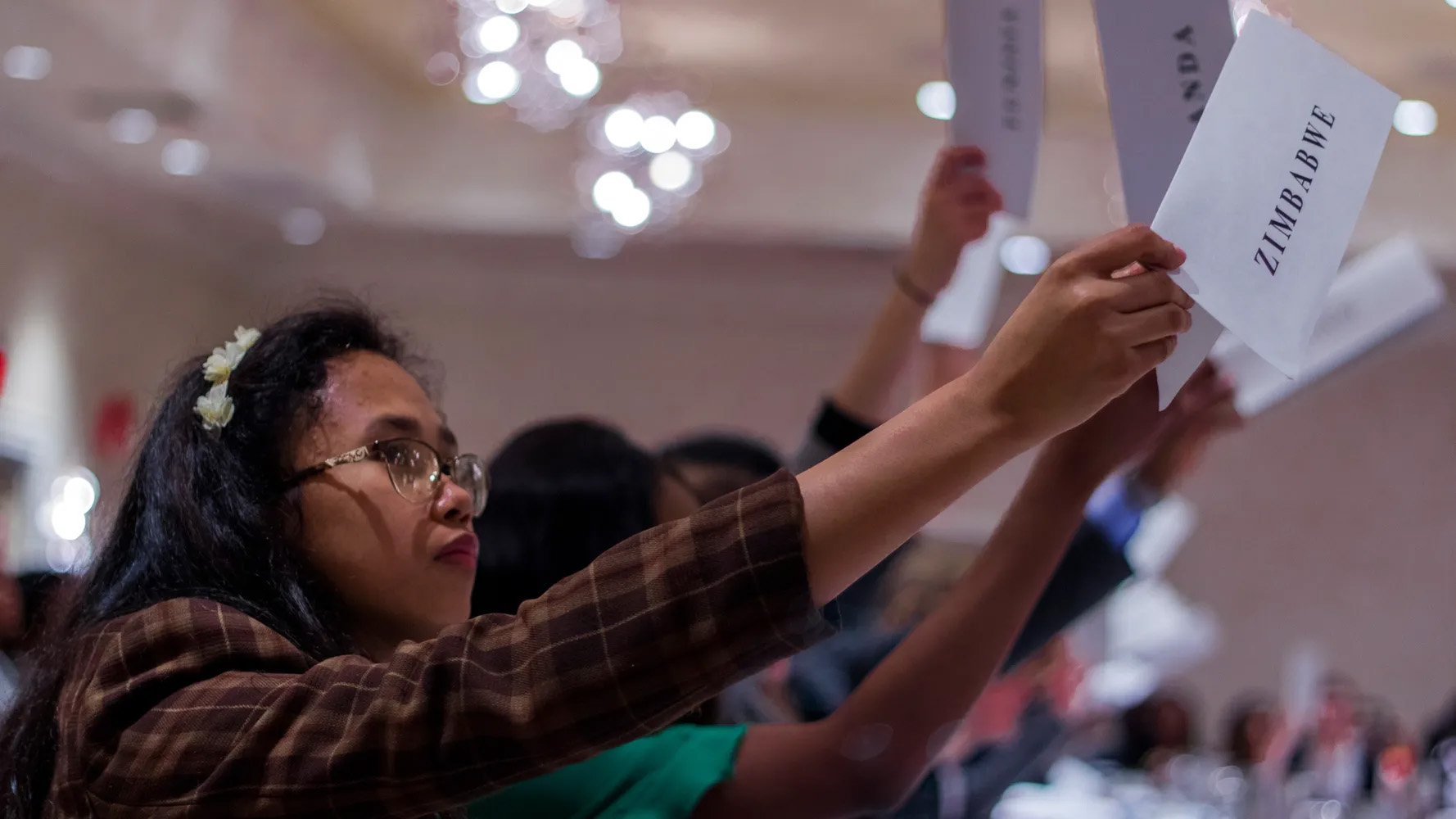 Woman holding up sign saying Zimbabwe