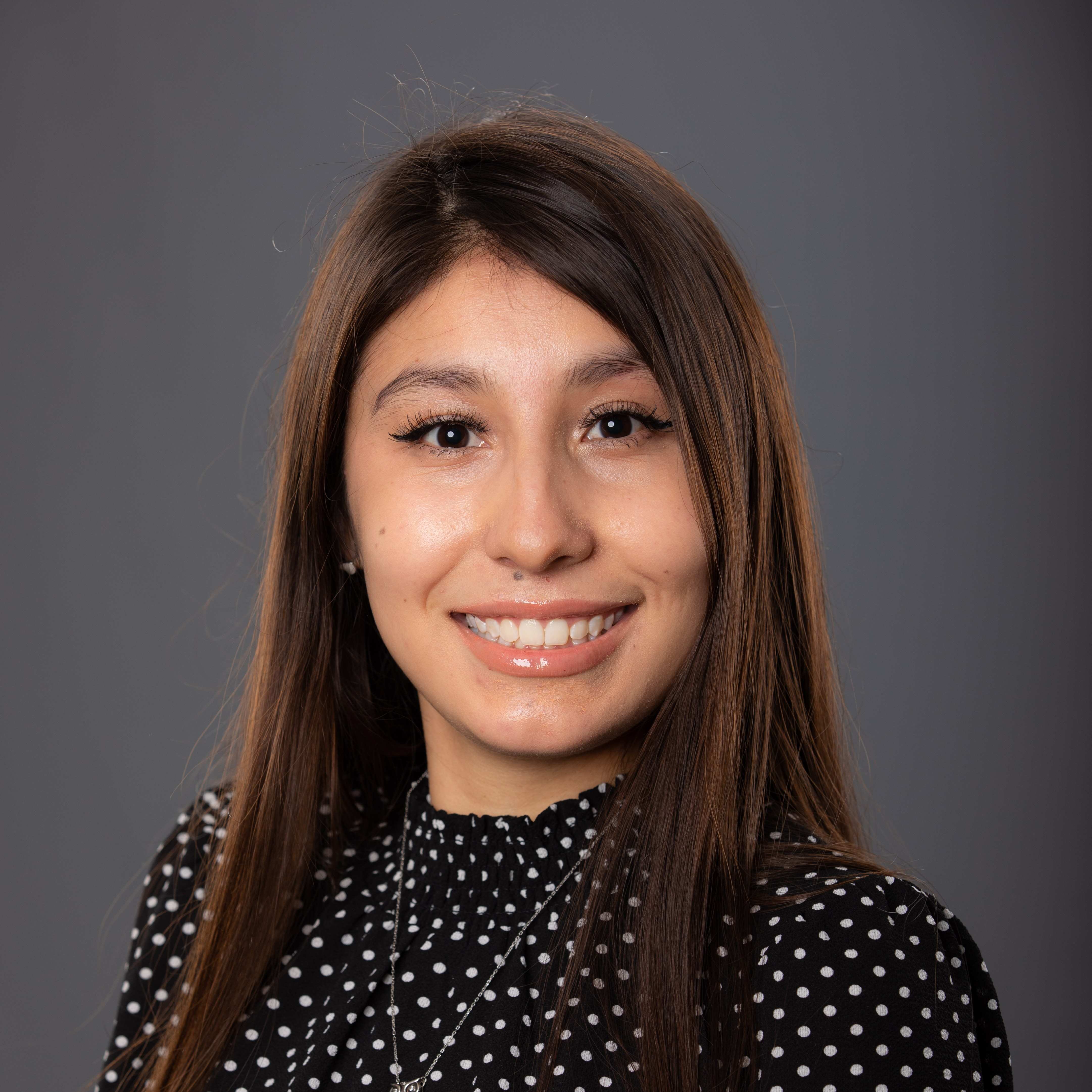 International Student Advisor Calli Rendon Sandoval against a gray backdrop