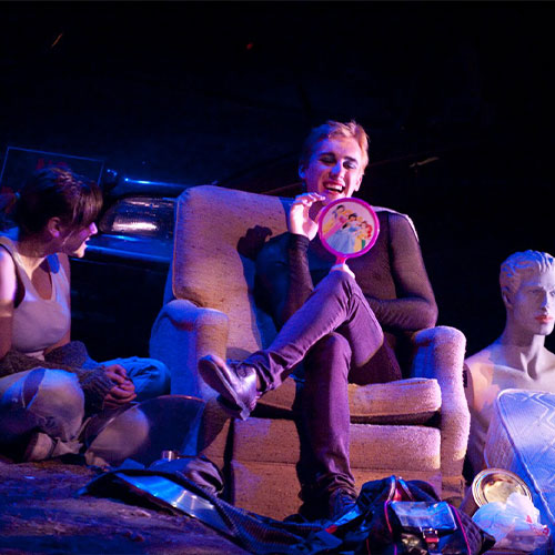 Woman sitting in chair holding a princess mirror.