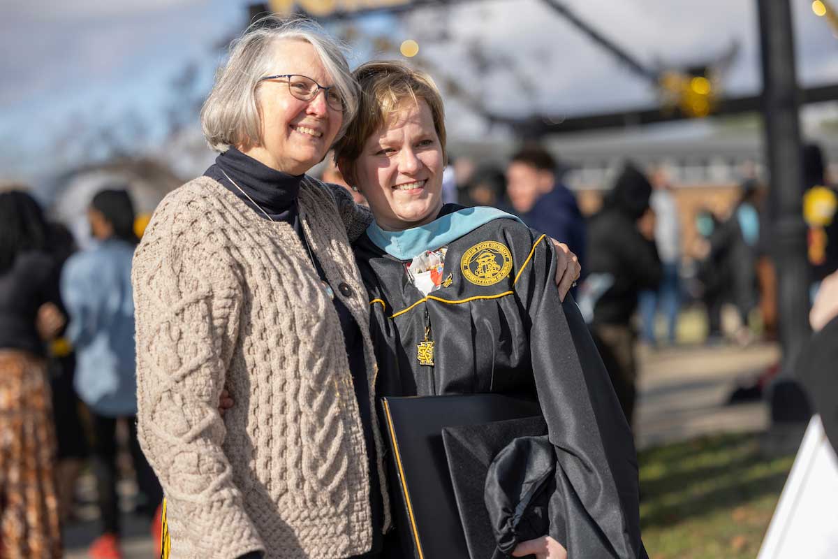 family at ksu commencement ceremony outside