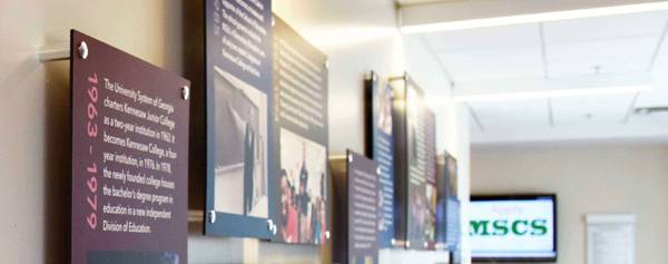 Collection of exhibit panels lining a hall.