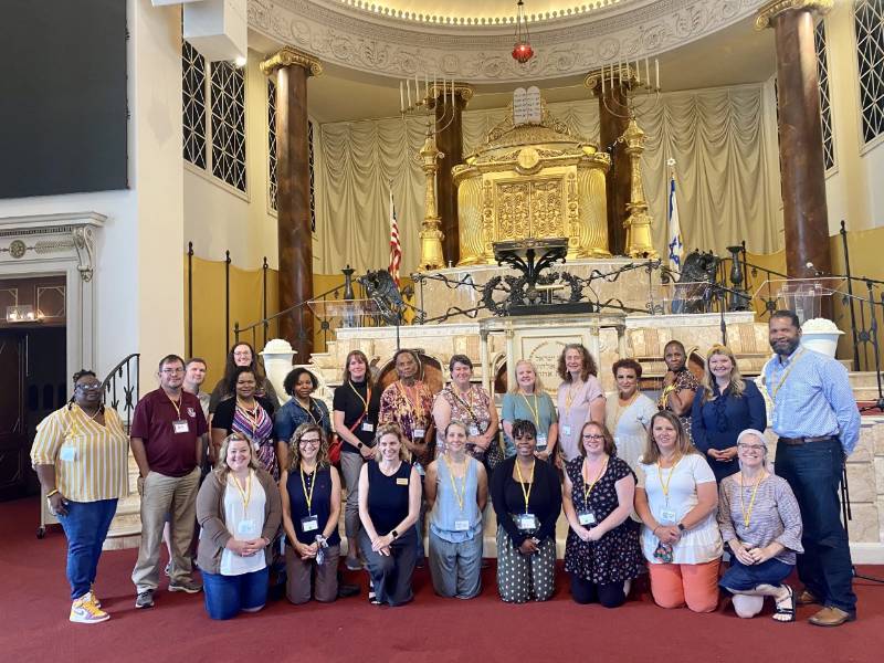 Teachers pose at the Museum of History and Holocaust Education