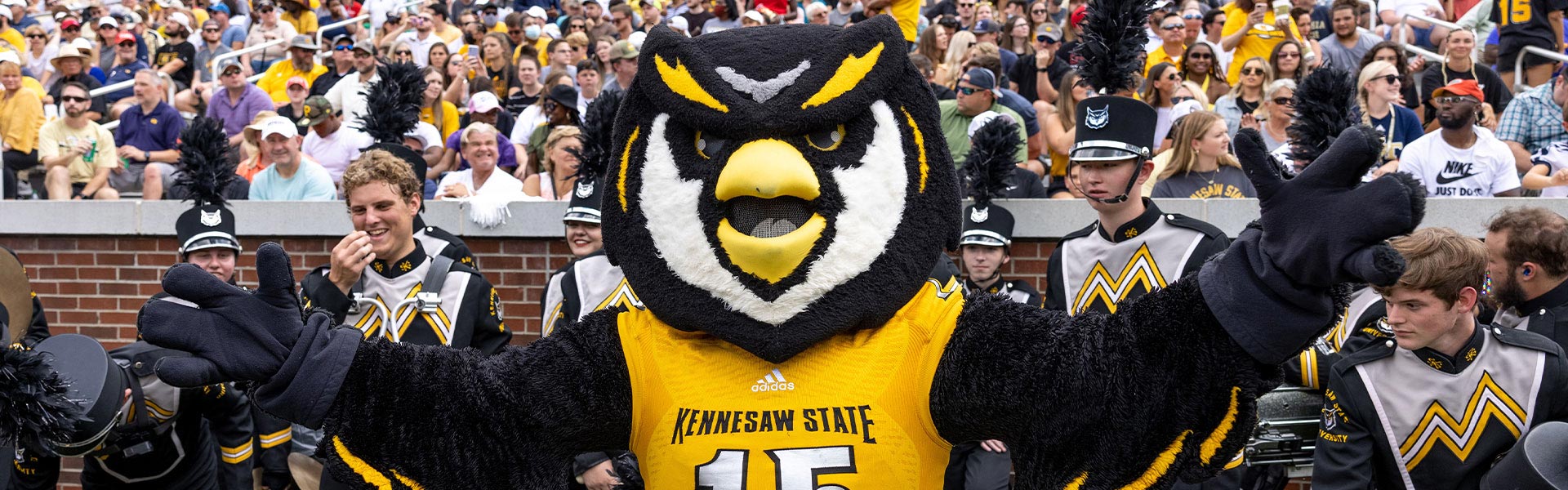 scrappy standing with the band during a football game.