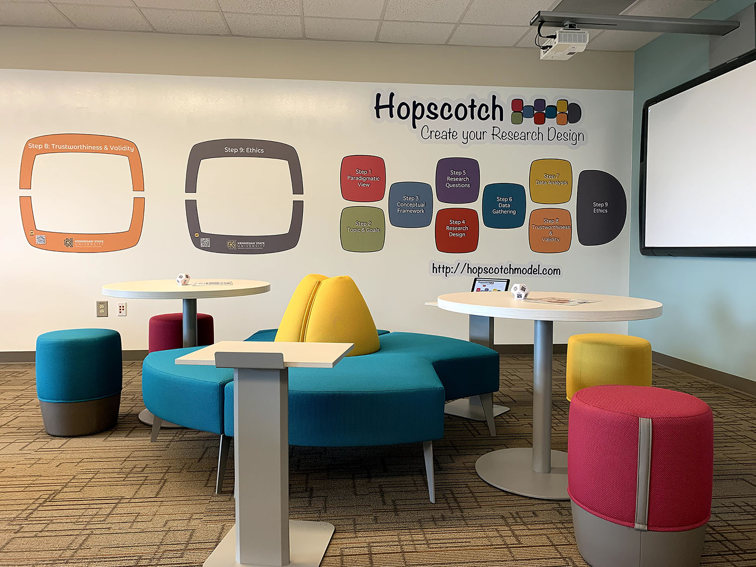 the hopscotch room with colorful tables and chairs