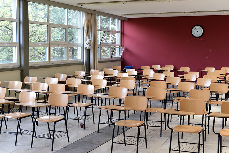 An image of a class room full of desks and chairs