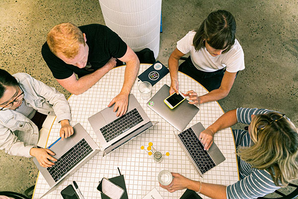 A small group of students working on their laptops together