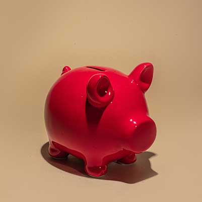 red piggy bank on brown background