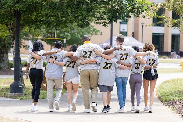 FLIGHT27 Students walking arm in arm