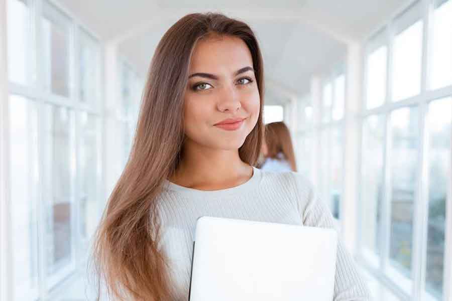 woman holding laptop.