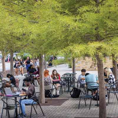 students sitting at tables outside ksu campus