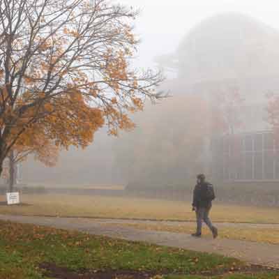 ksu student walking on campus during rainy day