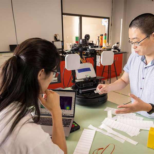 two ksu robotic students working on their project.