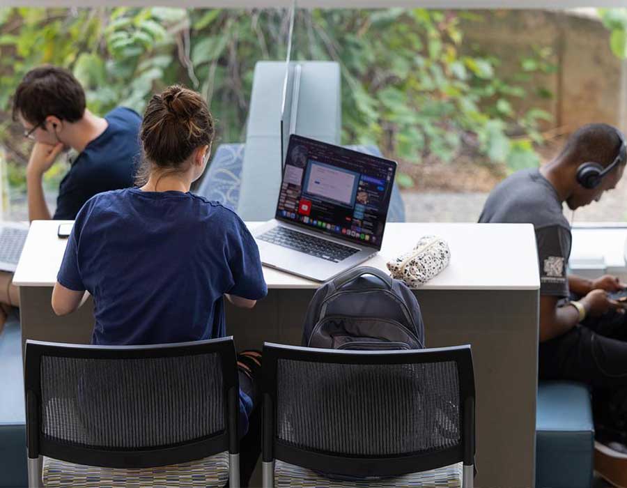 ksu students focused on their laptops studying.