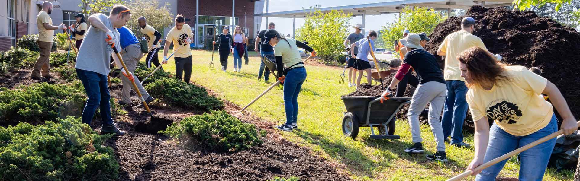 group of ksu students volunteering to help with taking care of the plants on campus.