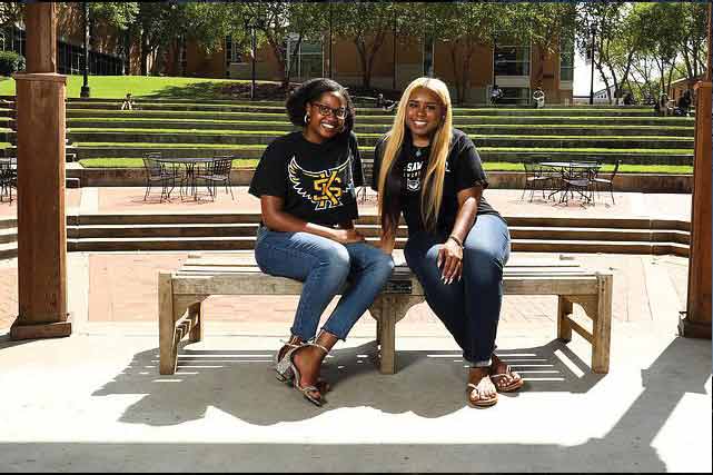 two ksu students sitting together outside