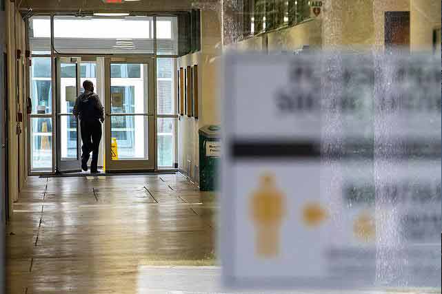 man walking down hallway on ksu campus