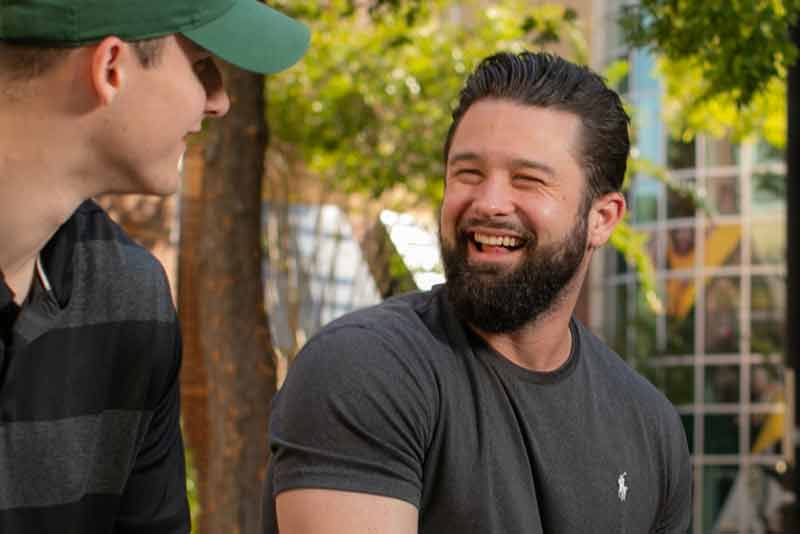 two young men having conversation outside