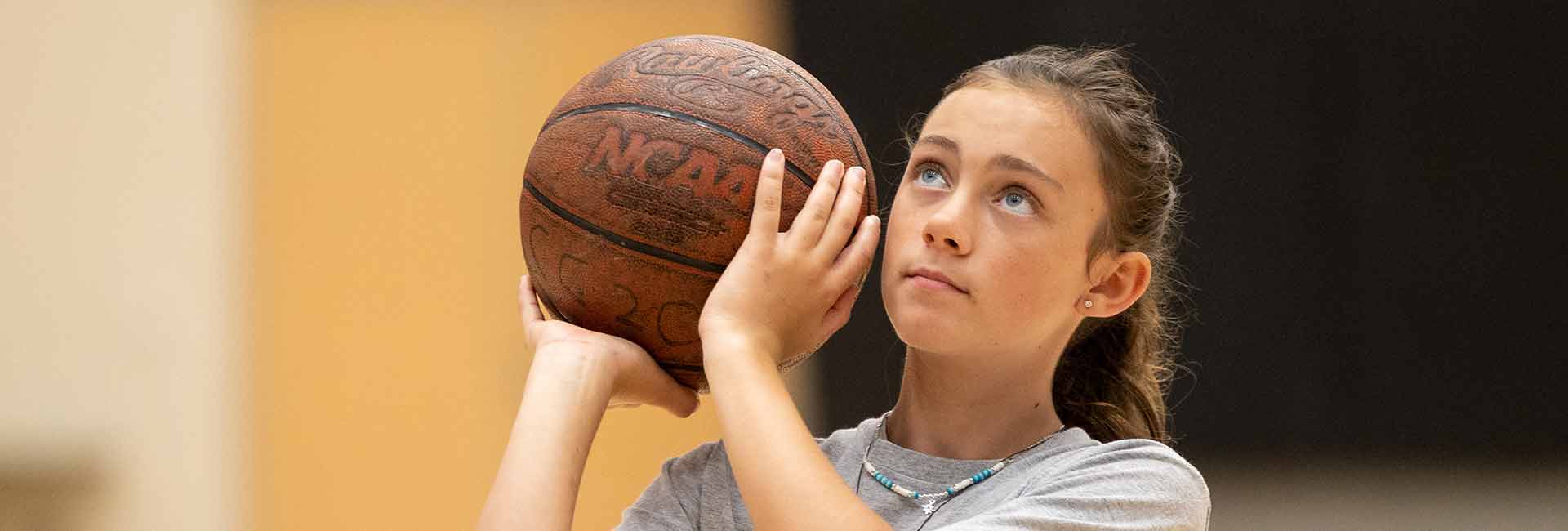 ksu student shooting basketball in gym