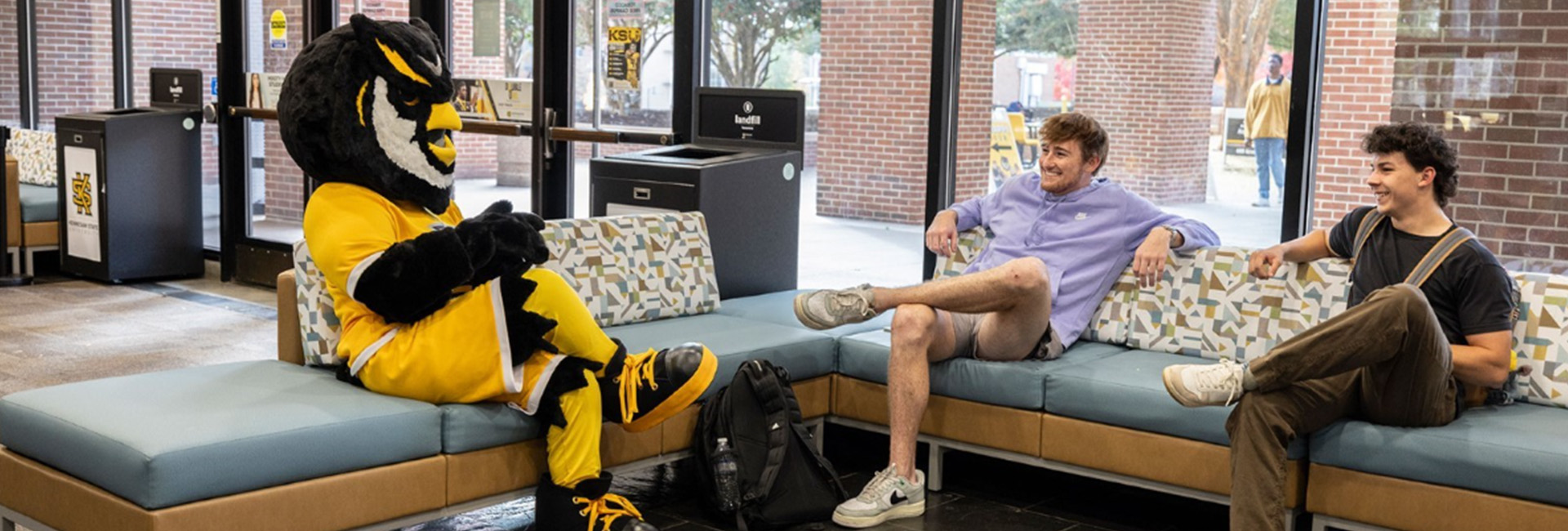 scrappy on couch with two students