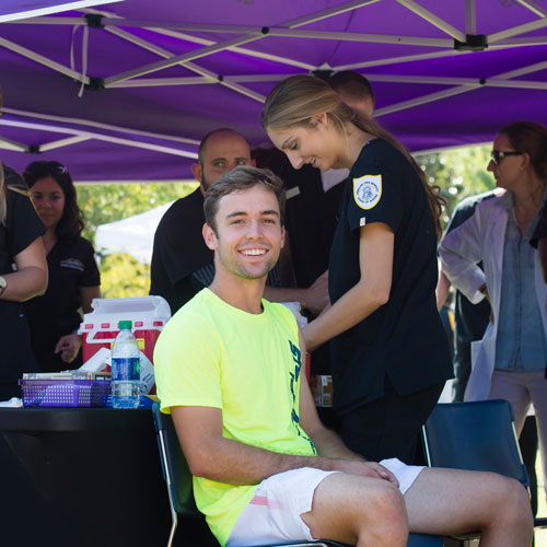 student nurse giving shot to fellow student