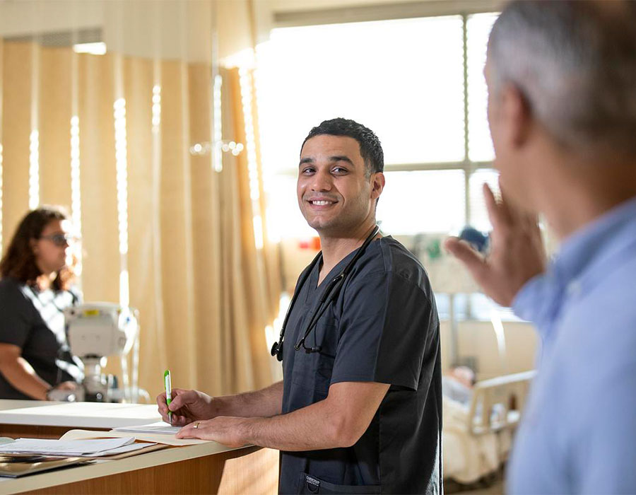 ksu faculty waving at a nursing student.