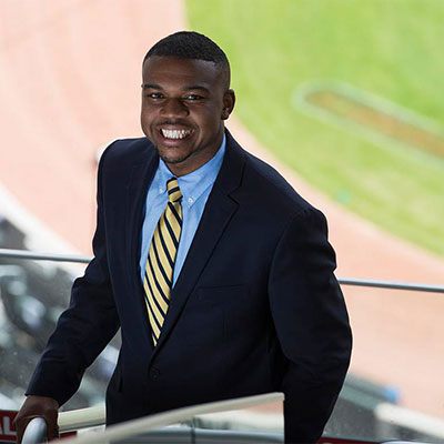 essm student at football field in suit